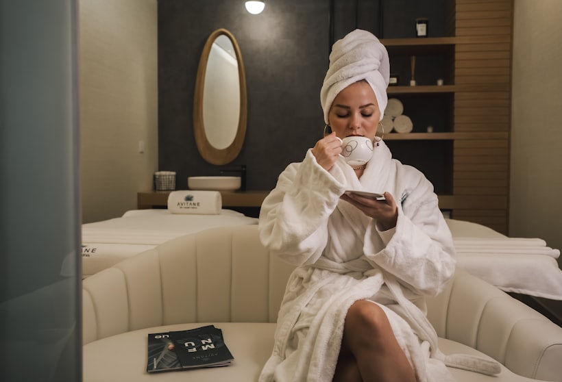 Guest in a robe with tea after a session